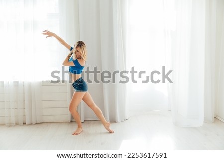 a dancer performs a modern Latin bachata dance in a dance studio dance hall on the dance floor Royalty-Free Stock Photo #2253617591