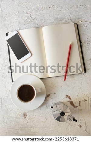 Modern office desk table with smartphone and other supplies with cup of coffee