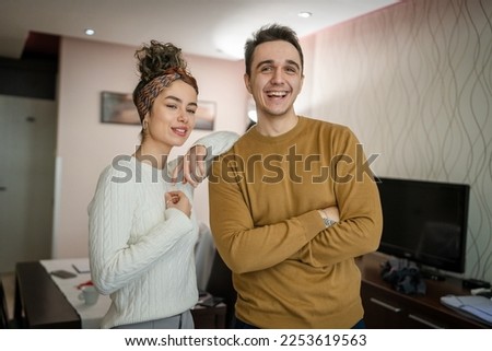 Happy couple woman and man caucasian husband and wife or girlfriend and boyfriend standing at home happy smile in their apartment real people copy space