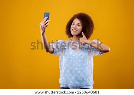 Young woman looking contened and making selfie