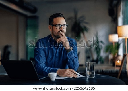 Focused man thinking about his next business project, looking thoghtful. Royalty-Free Stock Photo #2253642185