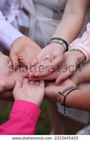 Young girls holding the promise ring. A bridal party. 