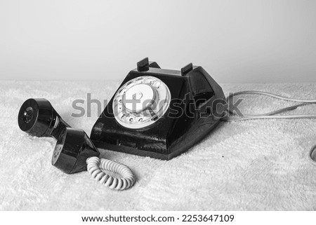 an old disk phone . black and white photo