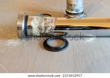 Metal drain siphon close-up with rusted pipes covered with corrosion Royalty-Free Stock Photo #2253652957