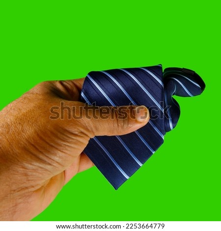human hand held necktie on green screen background, holding a tie with green color background single product display concept photography 