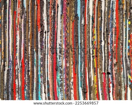 Striped motley handmade rug made of recycled rags.