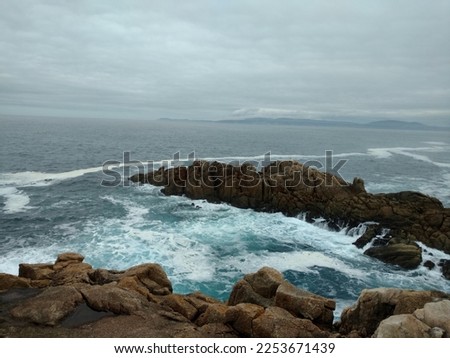 Galicia A Coruña roman lighthouse coast cliff rocks mist clouds sky white sea waves