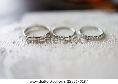Three silver wedding rings on white background macro