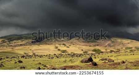 Dramatic clouds and rain on the southern foothills of the Haleakalā seen from the Piilani Highway Route 31 on the Hawaiian Island of Maui.