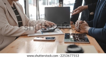 Businessman and Certified Public Accountant (CPA) auditor providing accounting and auditing services in the same company and stock market chart data and anti bribery of accounting Royalty-Free Stock Photo #2253677553