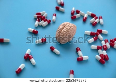 Concept of brain diseases, mental health, Alzheimer's, Parkinson's disease, dementia, stroke, and seizure. Nootropics use to improve memory and neural function. Brain model with a pills. Royalty-Free Stock Photo #2253698573