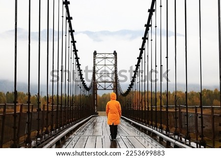 one person on the bridge from the back view, travel adventure, suspension bridge