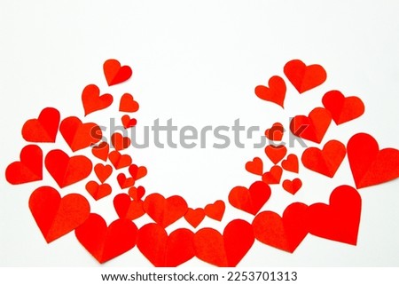 Valentine’s day background. Red hearts isolated on white. Love-shaped paper-cut decorations for International Women’s Day or Mother’s Day. Flat lay. Copy space