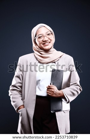 Cute young Asian hijab corporate girl with smooth glowing skin smiling and relaxing over an isolated background studio. Beauty skin care, office concept