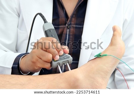 Somatosensory Evoked Potentials (SEP) or Nerve Conduction Velocity (NCV) is a test of electrical signals through a nerve, done in conjunction with an electromyography (EMG) to check the muscles Royalty-Free Stock Photo #2253714611