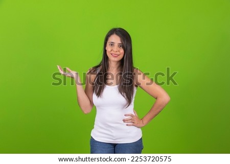 Young beautiful woman dressed casual points to the side with palm up