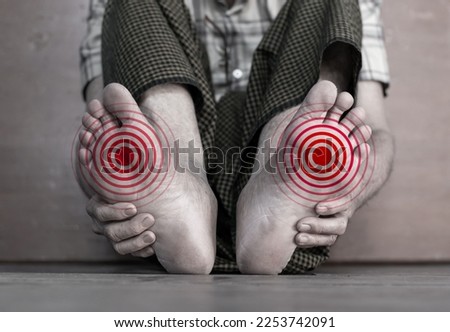 Tingling and burning sensation in foot of Asian elder man with diabetes. Foot pain. Sensory neuropathy problems. Foot nerves problems. Plantar fasciitis. Royalty-Free Stock Photo #2253742091