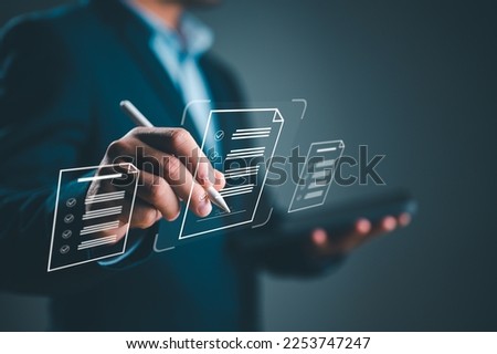 E-signing, electronic signature, document management, paperless office. Businessman signing on e document on digital tablet, virtual notepad on virtual screen, Online contract signing with application Royalty-Free Stock Photo #2253747247