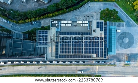 Top view of blue solar photo voltaic panels system on high apartment building roof top on sunny day. Renewable ecological green energy production concept.v Royalty-Free Stock Photo #2253780789