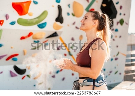 Climber wearing in climbing equipment. Practicing rock-climbing on a rock wall outdoor. Xtreme sports and bouldering concept.  rock climber climbs on a rocky wall.