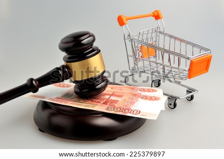 Hammer of auctioneer with pushcart and money on gray background Royalty-Free Stock Photo #225379897