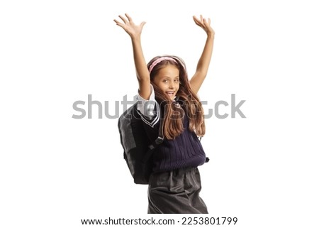 Schoolgirl with long hair jumping and gesturing happiness isolated on white background