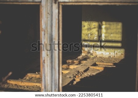 Close up sunlight through broken window on wall with flaky green paint concept photo. Front view photography with blurred background. High quality picture for wallpaper, travel blog, magazine, article