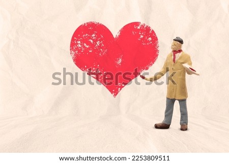 Miniature people, Artist holding paintbrush and painting with red heart shape on paper background, Valentine's day concept