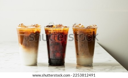 Ice americano and cafe latte on the table Royalty-Free Stock Photo #2253812491