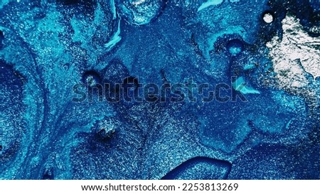 Fluid art. Abstract background. Glitter ink. Defocused sparkling silver white blue color bubble paint mix grain texture with free space.