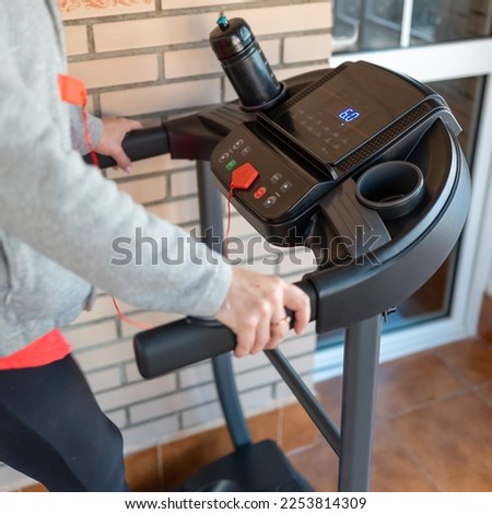 White woman riding on a gymnastics machine with different programs and options to keep fit.