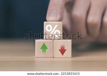 Wooden cube blocks with percentage icons and up or down arrows. business concept finance economy mortgage Bank interest rates, loans, investments, stock growth, and dividends.