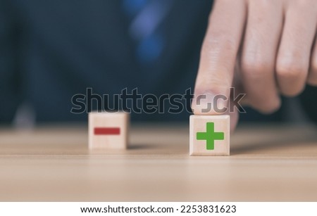 wooden block Show plus and minus symbols. The concept of opposites, decisions, and uncertainty. Positive or Negative Business Choices Analysis of advantages and disadvantages Comparison Royalty-Free Stock Photo #2253831623