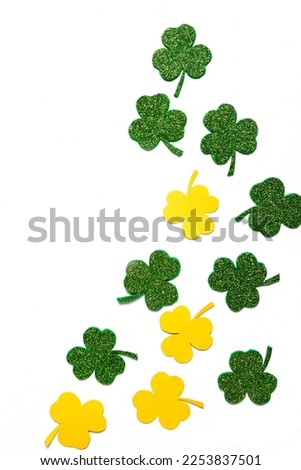 Happy St. Patrick's Day banner.Holiday background.St Patricks Day frame against a white background. Flat lay shamrocks.Copy space.Patrik's day banner Royalty-Free Stock Photo #2253837501