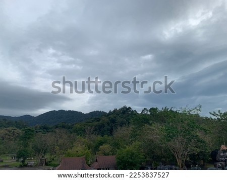 When the gray nimbostratus clouds roll in a layer above the sky Imagination is like a scallop shell and it rains continuously for a long time that at Trang, Thailand.no focus Royalty-Free Stock Photo #2253837527
