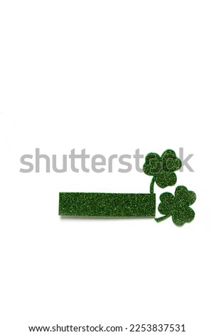 Happy St. Patrick's Day banner.Holiday background.St Patricks Day frame against a white background. Flat lay shamrocks.Copy space.Patrik's day banner Royalty-Free Stock Photo #2253837531