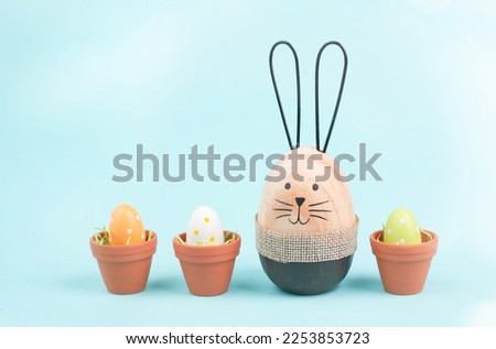 Cute easter bunny, baby rabbit with eggs in a flower pot, spring holiday greeting card 