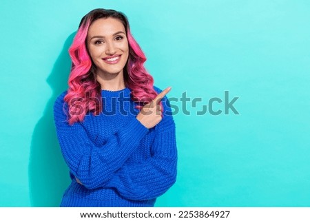 Portrait of satisfied vibrant woman with wavy hairstyle wear knit pullover directing empty space isolated on vivid teal color background