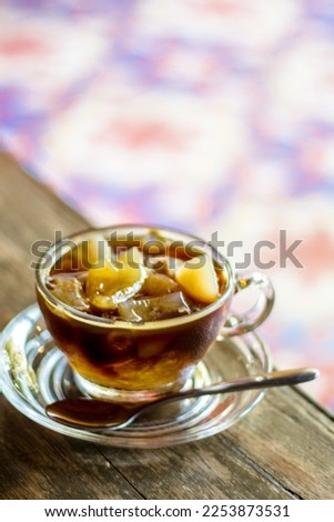 Coffee with fresh toddy palm,Coffee in a glass cup on wooden table in cafe with light background