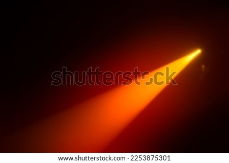Orange blurred beam of stage light on a dark background. Royalty-Free Stock Photo #2253875301