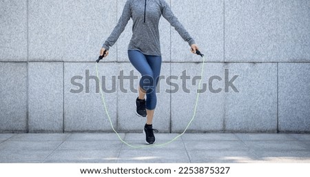 Fitness sports woman running up stairs in city Royalty-Free Stock Photo #2253875327