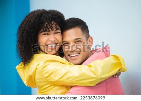 Couple, smile and hug in portrait with face, love and commitment, happiness isolated on blue background. Interracial relationship, support and together in studio with happy people and trust