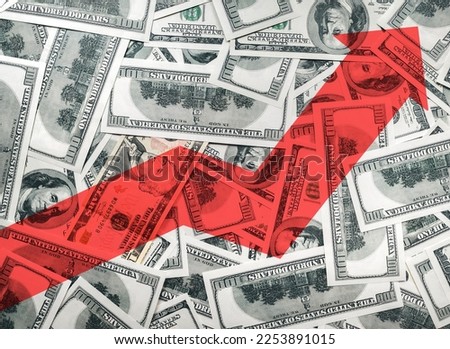 A large red arrow on the background of money shows the direction to the up. The concept of changing the exchange rate of the US dollar in the market. Economic growth, currency strengthening. Schedule.