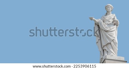 Old roof statue of a beautiful Renaissance Era woman philosopher and poet with a tea cup or food plate in Potsdam at white blue sky background and copy space, Germany Royalty-Free Stock Photo #2253906115