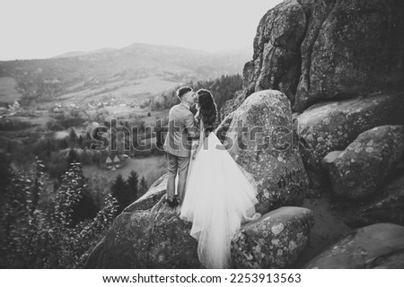 Loving husband and woman on the background of the mountains. Loving couple emotionally spends time