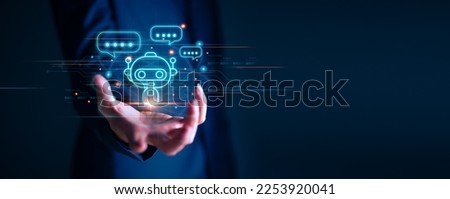 Businessman holding hologram digital chatbot, chat GPT, robot application, conversation assistant, AI Artificial Intelligence concept, digital chatbot on virtual screen. Royalty-Free Stock Photo #2253920041