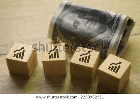 An icon of market increases or profits on a wooden cube. Business concept 