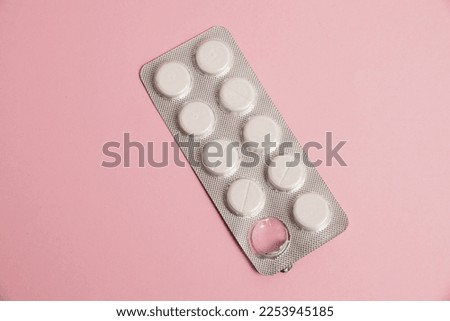 Opened blister pack with pills on a pink background. Concept of treatment of chronic diseases. Royalty-Free Stock Photo #2253945185