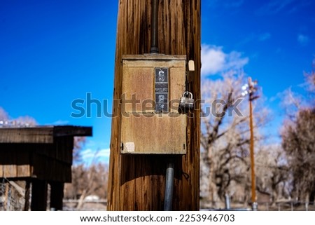 This is a photo of an electrical box on a light pole. 