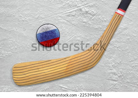 Hockey stick and puck on the Russian ice. Fragment